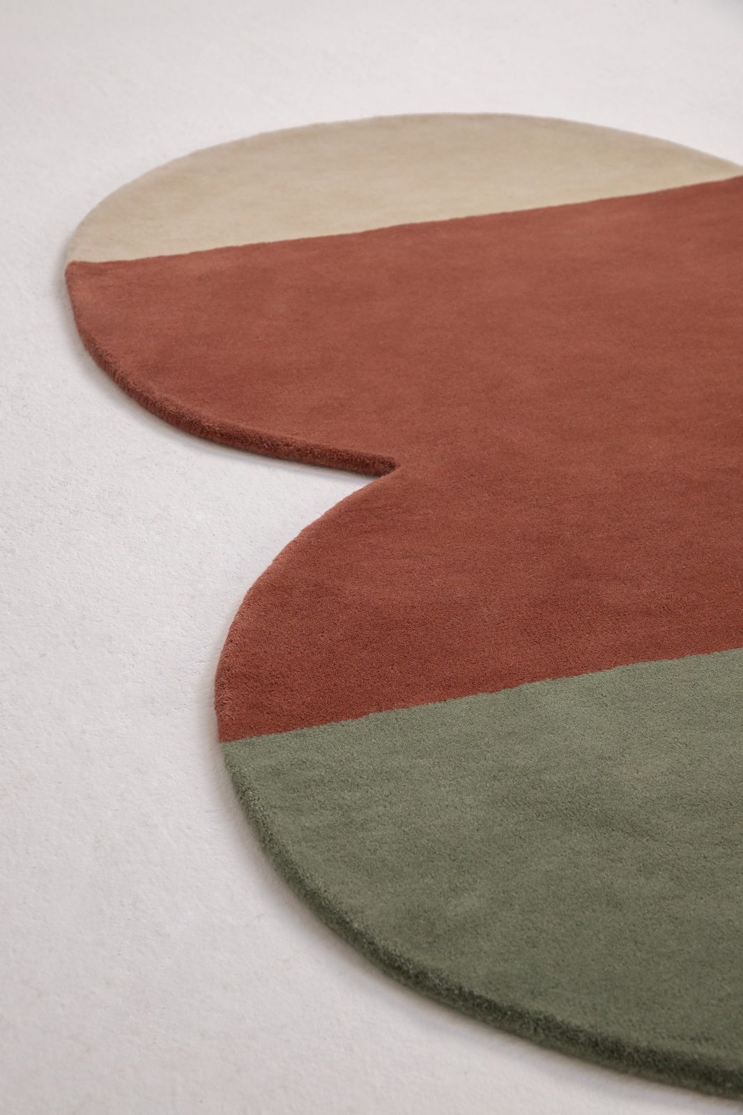 Detailaufnahme des Nanimarquina Teppichs "Pearls Runner" in Beige, Rostrot und Grün.